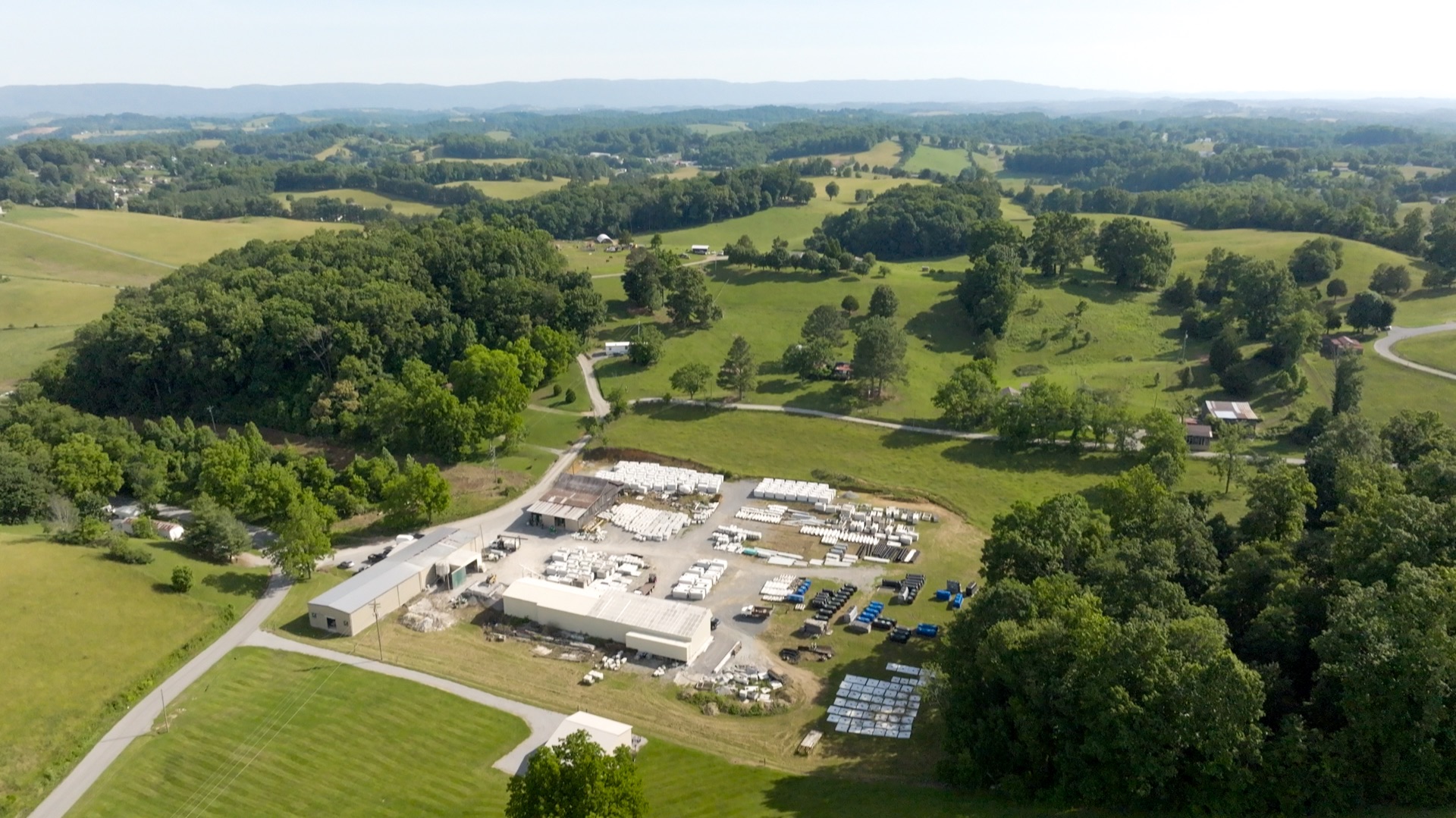 Aerial view of the Daniels Septic and Precast facility set in the rolling hills of Tazewell, TN with the Appalachian foothills in the distance