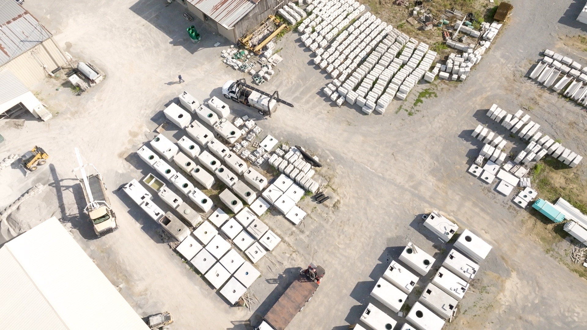 Aerial view of the Daniels Septic and Precast yard in Tazewell, TN with rows of precast concrete tanks ready for delivery
